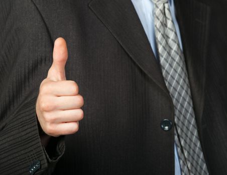 A photo of a hand doing a thumb up gesture. Focus on thumb