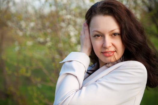 Portrait of the attractive woman. Against the spring nature