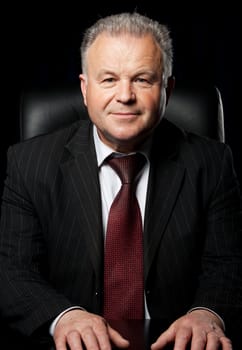 Portrait of the elderly man. A photo against a dark background