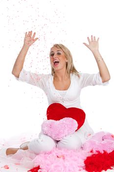 Cute young girl with excited look and confetti for valentine