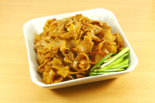 Thai Spicy Fried Noodles On a White Dish Plate