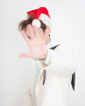 The person in a Christmas cap closes the face a hand