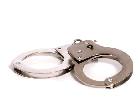 A metal pair of handcuffs shot against a white background