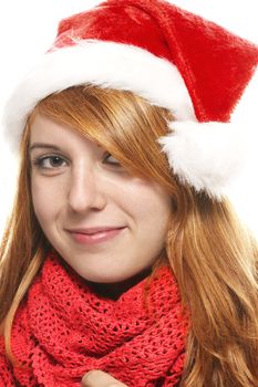 smiling redhead young woman with santas hat on white background