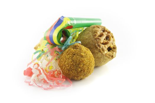 Small tasty pork pie, small round scotch egg and streamers with party blower on a reflective white background