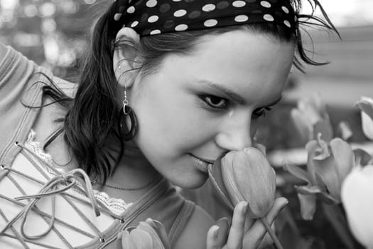 Teen girl smelling a tulip