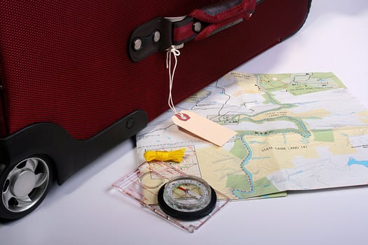 Red big suitcase with label and map for travel.