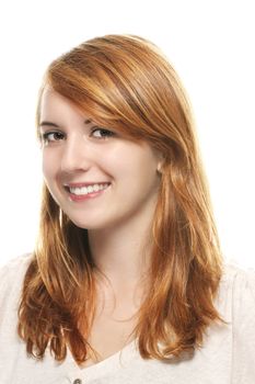 portrait of a young smiling redhead woman on white background