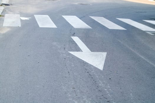 White direction arrow on the road 