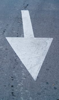 White direction arrow on the road 