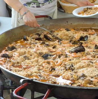 A one big paella for hundred person