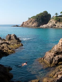 A young boy Swimming under water in the costa brava, Spain.