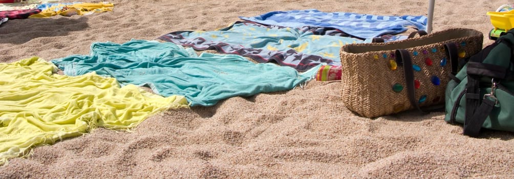 Closeup of Towels in the beach with casual bag.