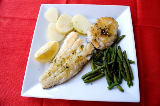 Sole and hake with potatoes and vegetables