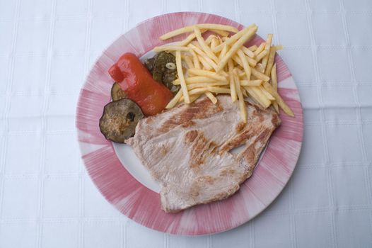 plate of steak with chips and vegetables