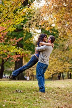 A man and woman hugging in a park