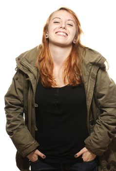 happy young redhead woman in parka on white background