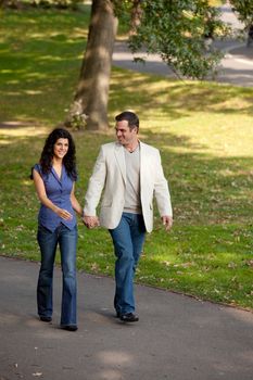 A happy couple walking in the park