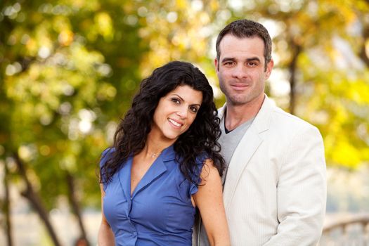 A portrait of a happy male and female in a park