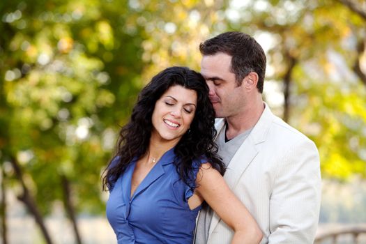 A man and woman showing affection in a park