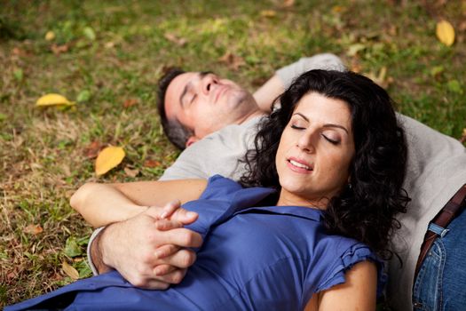 A couple taking a refreshing break outdoors in a park - sharp focus on female