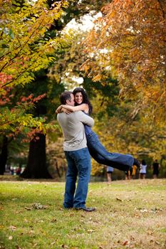 A man giving a bear hug to a woman 