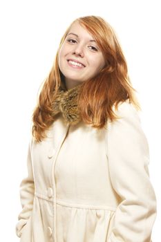 young happy redhead woman in fawn winter coat on white background