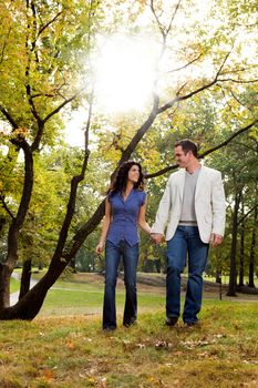 A happy couple walking in the park - looking at each other