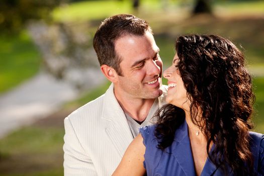 A couple in the park happy and about to kiss