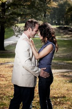 A happy couple looking at eachother in a park