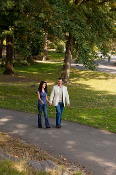 A happy couple walking in the park