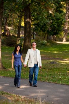 A happy couple walking in the park 