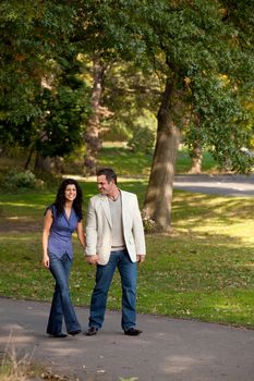 A couple happy and walking in a park