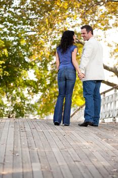 A happy engagement couple walking in the park on a beautiful day