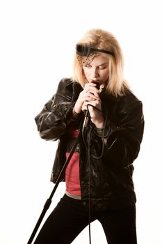Pretty young female blonde singer or comedian with microphone