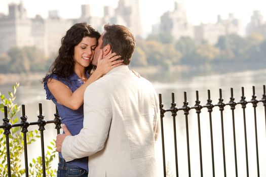 A man and woman kissing in the park