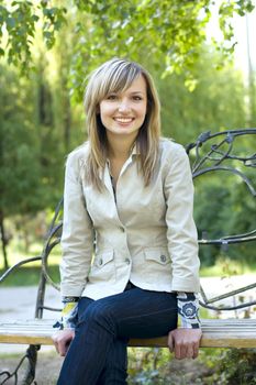 Young blond woman relaxing outdoors in a park on a warm summer day