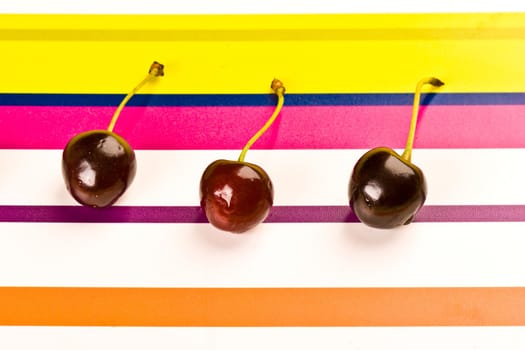 some ripe cherries on the colored background