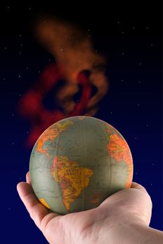 Male hand holding globe in outer space