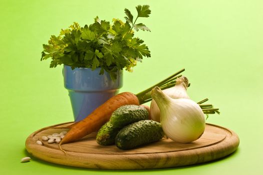 vegeterian food, fresh vegetables: onion, carrot, cucumber and parsley