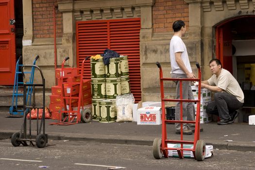 two men deliver goods to a chinese store