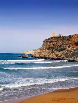 Clear blue Mediterranean waters on windy day, with beach and typical rocky coastline
