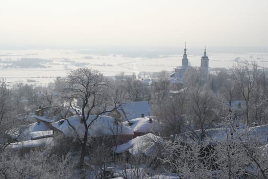 A winter landscape of a little town