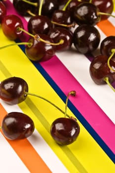 some ripe cherries on the colored background