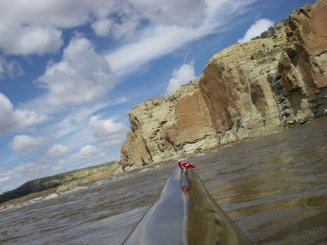 view from a bow of racing kayak on the North Platte River in Wyoming