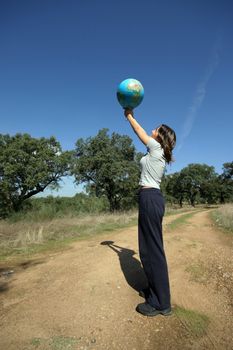 girl holding earth in the nature