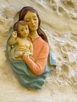 Little door icon typical of many villages in Malta - religious motif of Madonna and child