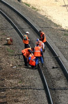 Workers in orange jacket make checkup 