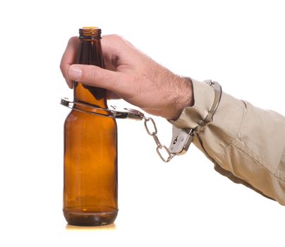 A mans hand is handcuffed to a bottle of beer, isolated against a white background