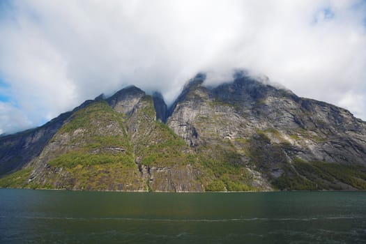 The Geiranger fjord in Norway, surrounded by high mountains